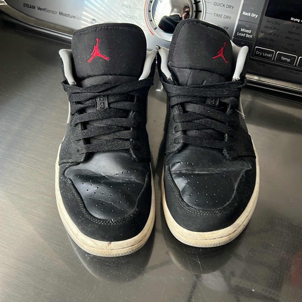 Black gray and red Nike Jordan’s